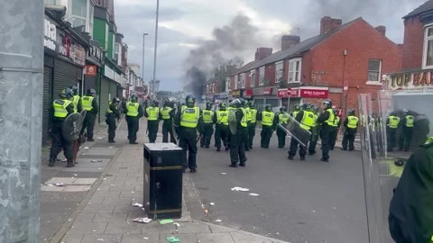 Car set on fire as rioters clash with police in Middlesborough Stock Footage 280925163