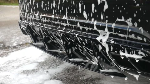 Car shampoo soaking on rear diffuser Stock Footage 142718951