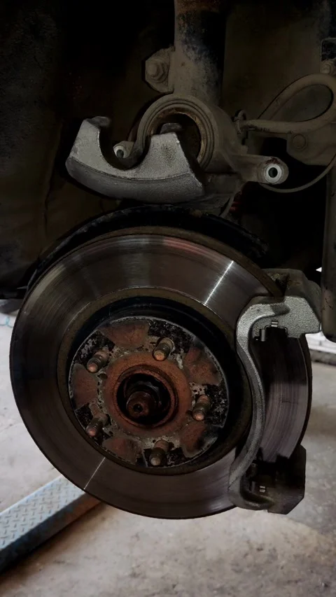 Car shock absorber and drum brake inside a wheel well Stock Footage 333701059