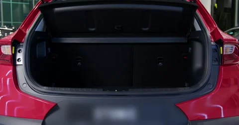 The car in the showroom automatic trunk opening. Demonstrating new car Stock Footage 304090348