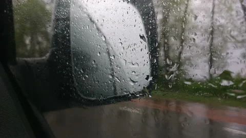 Car side mirror and drivers window with drops of rain Stock Footage 113326397