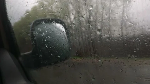 Car side mirror and drivers window with drops of rain Stock Footage 113354286