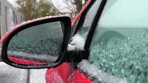 Car side mirror and window in hail storm, handheld video. Видео 266700293