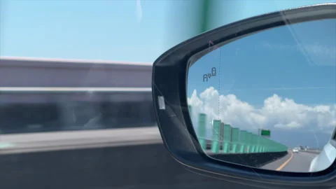 Car Side Mirror Reflecting Clouds While Driving On An Elevated Highway Stock Footage 342815015