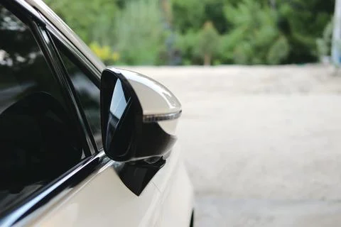 Car side mirror reflection outdoor parking lot greenery surroundings close-.. Stock Photos