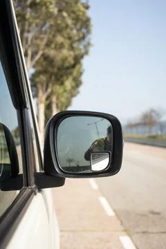 Car side mirror reflection road visibility awareness Stock Photos