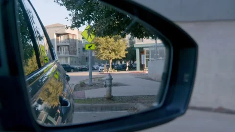 Car Side Mirror Reflection of Urban Street Sidewalk with Pedestrian Stock Footage 301490372