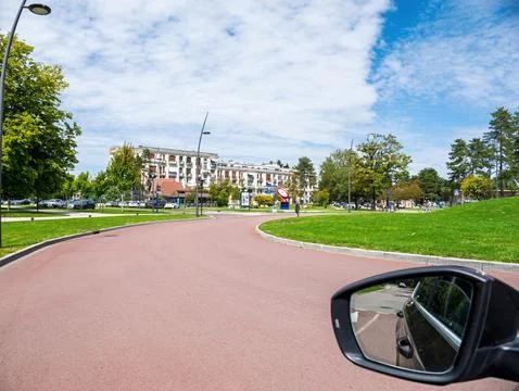Car side mirror view of boulevard with green lawn in Le Touquet Fotos de archivo