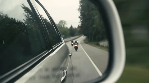 Car Side Mirror View of Motorcyclists on a Highway Vídeos de archivo 107442216