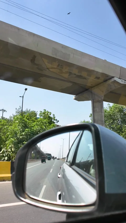 Car Side Mirror View with Traffic and Flyover Stock Footage 342792617