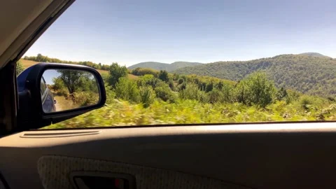 Car Side Mirror View.Close-Up View Of Side Mirror From Vehicle On Mountain Road. Stock Footage 149370134