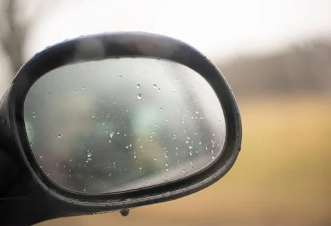 Car side view mirror with rain drops Stock Photos