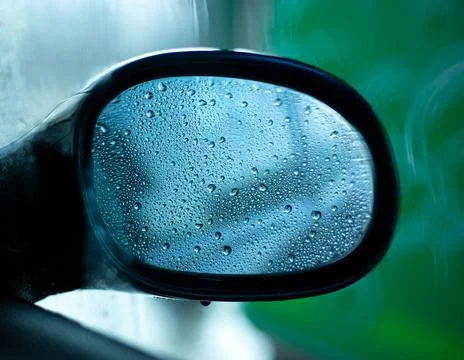 Car side view mirror with rain drops Stock Photos