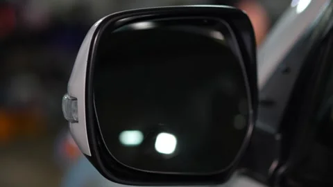 Car side view mirror with a white outer housing, an integrated clear turn sig Stock Footage 344597279