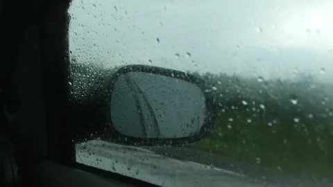 Car side window with dreary overcast sky with rain view Stock Footage 283684542