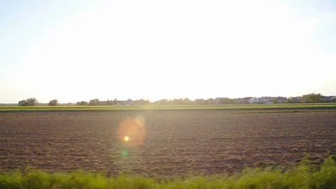 Car side window view of empty farmland sun flares shine 4K Video stock 89567740