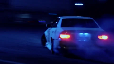 A car in a skid with fire from the exhaust pipe is speeding in a skid. Russ.. Stock Footage 320797612