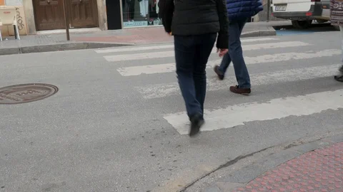 Car slowing down at crosswalk to let pedestrian cross the street. Stock Footage 122012195