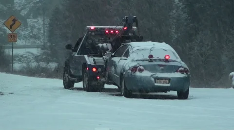 Car in Snow Storm About to be Towed by Truck 動画素材 54757121