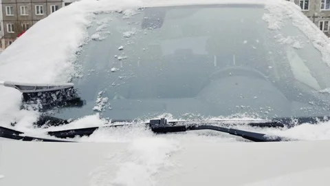 A car with snow on the windshield and wipers 스톡 동영상 269868221