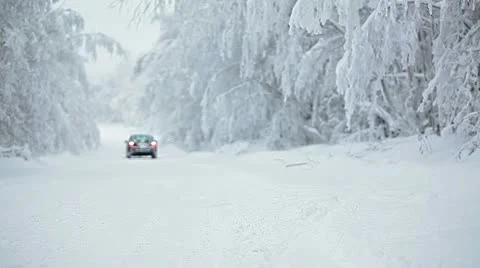 Car on snowy road reversing to camera Stock Footage 19892045