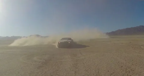 Car  speeding at camera with Dust Stock Footage 58461173
