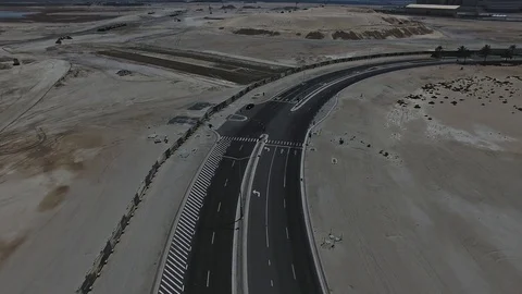 Car speeding down the road in Abu Dhabi aerial view Stock Footage