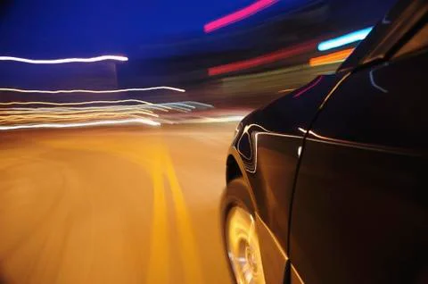 Car speeding at dusk Stock Photos