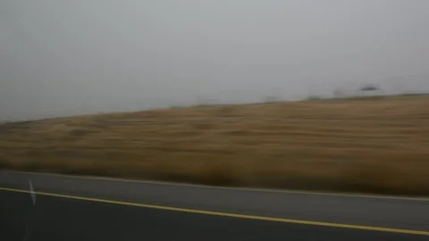 Car speeding on a road through green fields - side window blurred motion view 스톡 동영상 109404302