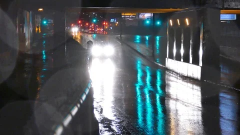 Car speedly passing during rainy night Stock Footage 125552617