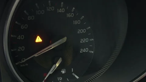 Car speedometer dashboard with glowing warning indicator, fuel gauge, and needle Stock Footage 344992328
