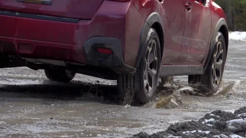 Car splashing in rough muddy potholes close slowmo 스톡 동영상 150714882