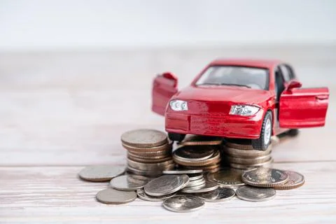 Car on stack of coins. Car loan, Finance, saving money, insurance and leasi.. Stock Photos