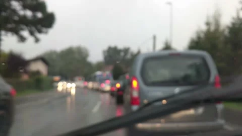 Car standing in stopped traffic during rush hour on a rainy cloudy day Video stock 150466403