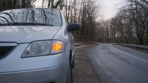 The car stands on the side of the road and blinks a yellow emergency light. Stock Footage 124304563