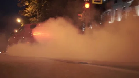 Car start with smoke on wheels. Footage. Red modern drag sport auto burning tire Stock Footage 143003151