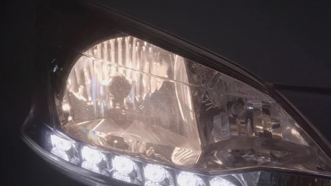 Car starting engine and turn on headlights at night. (recorded with quality a Stock Footage 112112428