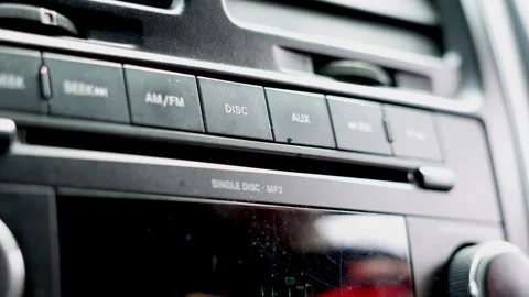 Car stereo CD player close up. Road trip listening to tunes. Vídeos de archivo 310816245