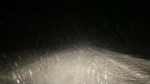 Car stopped at winter night road, falling snow in headlight Stock Footage 45945705