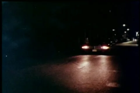 Car stopping at stoplight at night Stock Footage 11346064