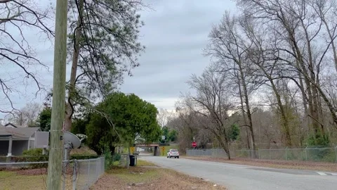 A car stops at a stop sign at the Olive Road bridge which is only 10 foot 5 i Stock Footage 147096801