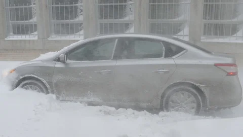 Car stuck in impressive snowfall Stock Footage 103869635