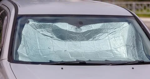 A car with a sunshade on the windshield Stock Photos