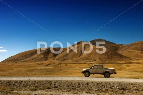 Car SUV on the mountains background Stock Photos