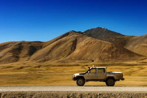 Car SUV on the mountains background Stock Photos