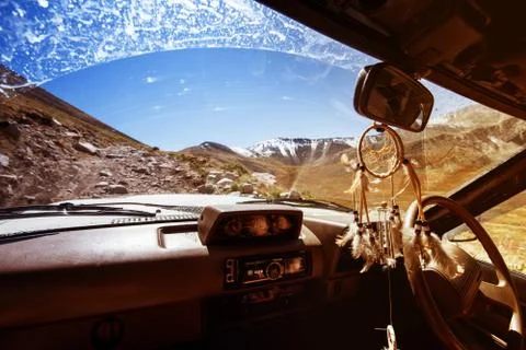 Car SUV on the mountains background window view Stock Photos