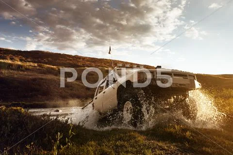 Car SUV overcomes water on the offroad background Stock Photos