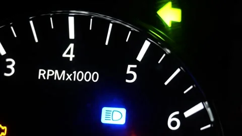 Car tachometer gauge with glowing indicator symbols at night Video stock 336661291