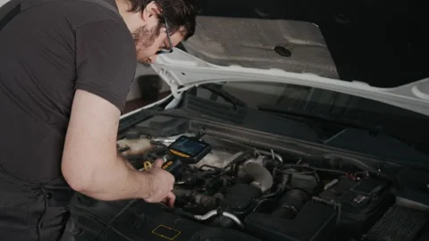 Car Technician With Remote Inspection Endoscope Examining Engine for Faults Stock Footage 329409376