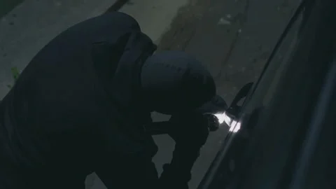 Car Thief Caught in the Act Using Tools at Night Stock Footage 321036286